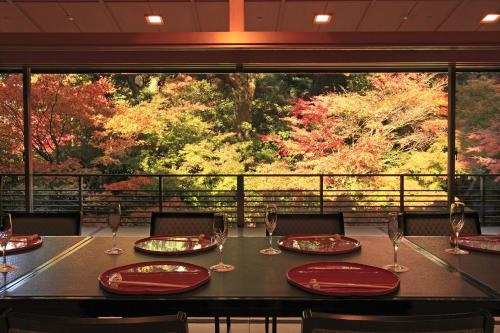 a table with red plates and wine glasses on it at Hotel Chinzanso Tokyo in Tokyo