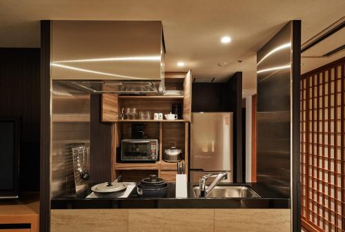 a kitchen with a sink and a microwave at Tokyu Vacations Kyoto in Kyoto