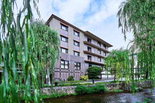 an apartment building next to a body of water at Tokyu Vacations Kyoto in Kyoto
