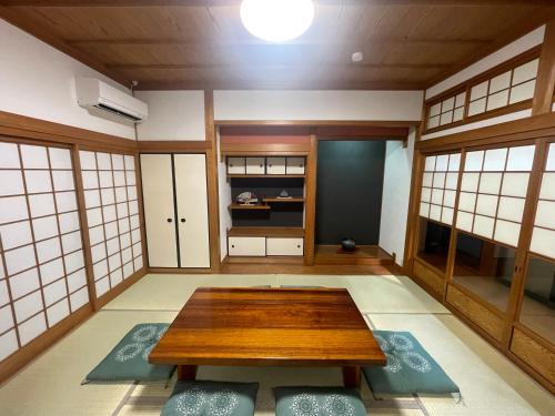 a room with a table in the middle of it at 徳治郎の宿 in Izumi-Sano