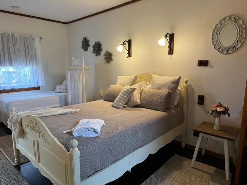 a bedroom with a bed with a towel on it at The Table Guest House in Greta