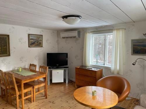a living room with a table and a dining room at Awesome Home In Motala With Wifi And 0 Bedrooms in Motala