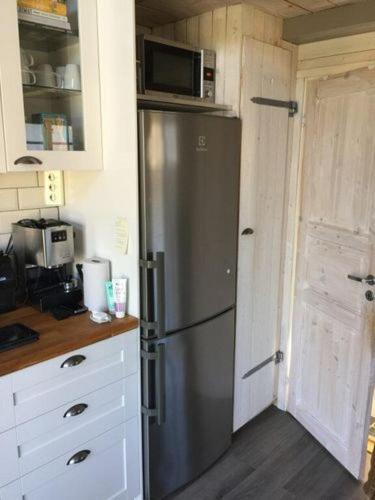 a kitchen with a stainless steel refrigerator with a microwave at Awesome Home In Drottningsskär With 0 Bedrooms in Drottningskär