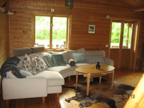 a living room with a couch and a table at Awesome Home In Mellerud With 3 Bedrooms And Sauna in Mellerud