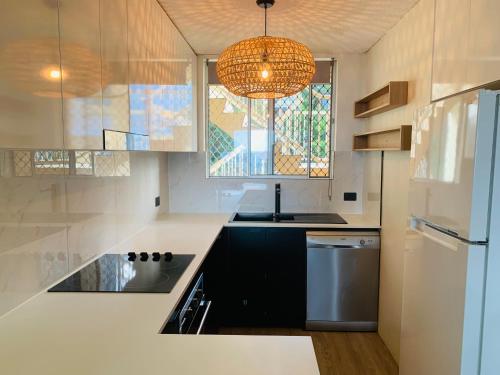 a kitchen with a sink and a refrigerator at Park Towers-Goodwin Towers Holiday Units in Gold Coast
