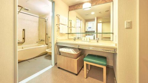 a bathroom with a sink and a toilet and a tub at Tokyu Vacations Hakone Gora in Hakone