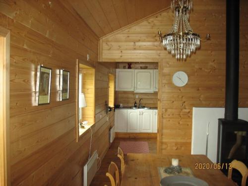 a kitchen with a dining table and a chandelier at Stunning Home In Mellerud With 3 Bedrooms in Mellerud