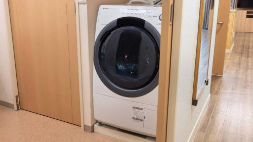 a washing machine sitting in a door of a room at Tokyu Vacations Hakone Gora in Hakone