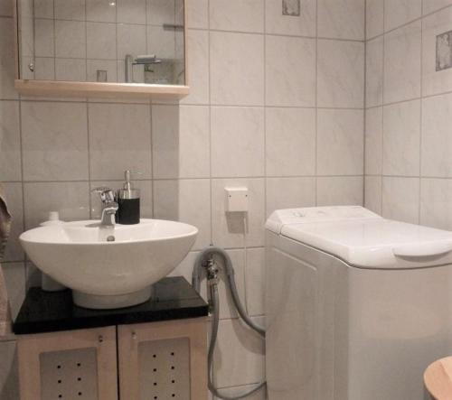 a white bathroom with a sink and a toilet at Beautiful Home In Karlshamn With 2 Bedrooms And Wifi in Karlshamn