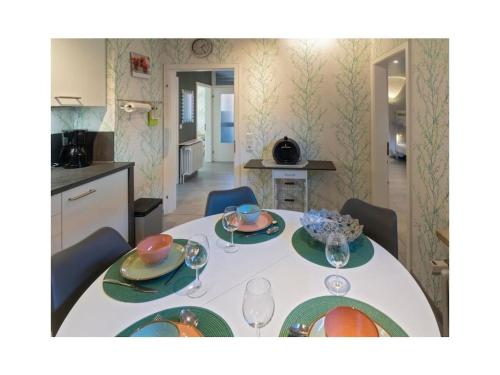 a table with plates and glasses on it in a kitchen at Holiday apartment Möwenblick in Norden