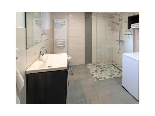 a bathroom with a sink and a shower at Holiday apartment Möwenblick in Norden