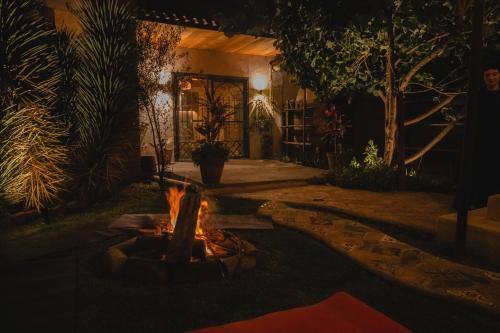 a fire pit in front of a house at night at Casa Hala LOFT & SPA LUXURY in León