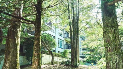 a white building with trees in front of it at Tokyu Vacations Hakone Gora in Hakone