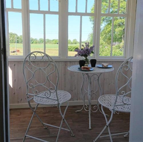two chairs and a table in front of a window at Stunning Home In Bergkvara With 4 Bedrooms in Bergkvara