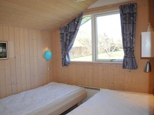 a small room with a bed and a window at Nice Home In Farsø W- in Farsø