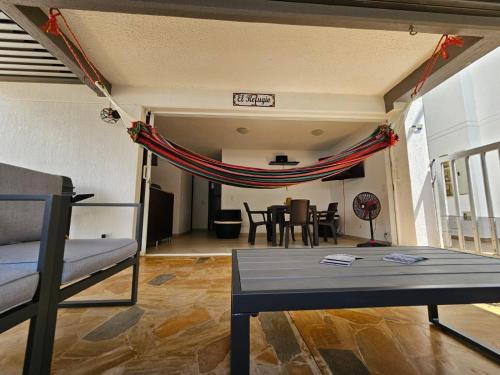 a living room with a couch and a table at Apartasol Ciudadela Santa Fé "El Refugio" in Santa Fe de Antioquia