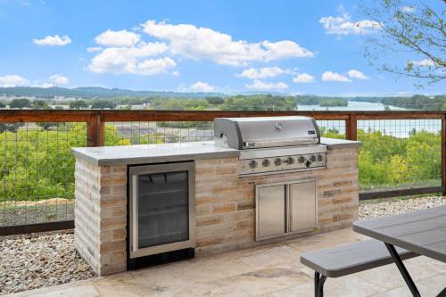 a brick barbecue with a grill on a patio at Guadalupe Bluff Mediterranean in Kerrville