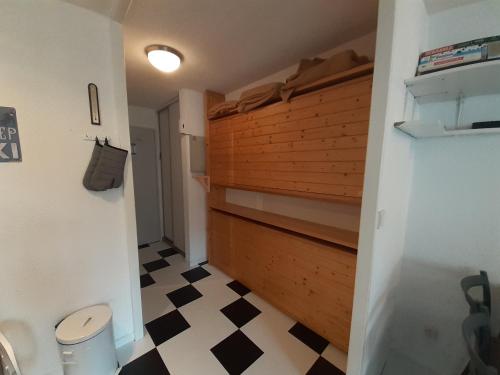 La salle de bains est pourvue d'un mur en bois et de toilettes. dans l'établissement Studio cosy proche télécabine à Valfréjus - FR-1-561-130, à Modane