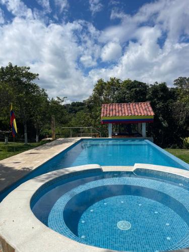 a swimming pool with a gazebo on top of it at Finca Villa Sophia! in Quimbaya