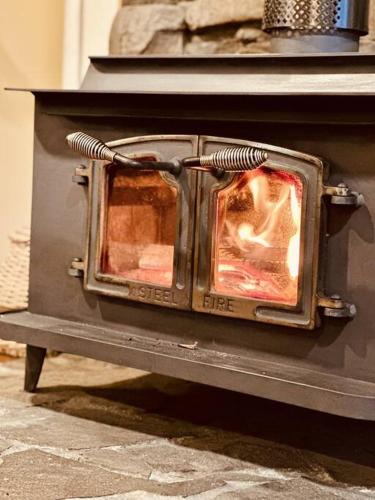 an oven with a fire inside of it at The Gums - Bruny Island in Woodbridge