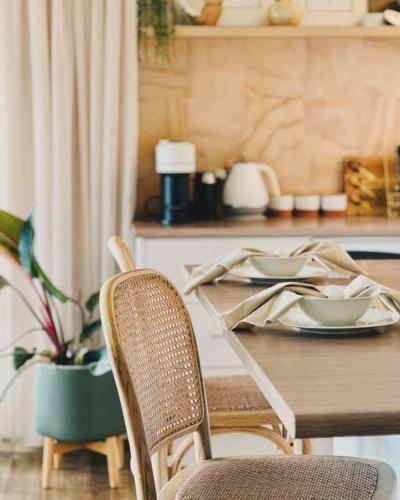 a wooden table with two plates of food on it at The Gums - Bruny Island in Woodbridge