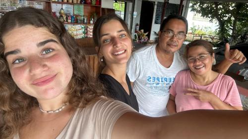 a group of people posing for a picture at RNA Guesthouse in Moalboal