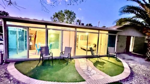 a house with a yard with chairs on the grass at Apartment A, Restful,Cozy, close Sunland Park Mall in El Paso