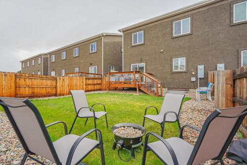 a group of chairs sitting in a yard in front of a building at Orchid Oasis - 2 Kings Foosball BBQ Fire Pit in Colorado Springs
