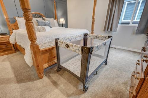 a bedroom with a bed with a wooden frame at Orchid Oasis - 2 Kings Foosball BBQ Fire Pit in Colorado Springs