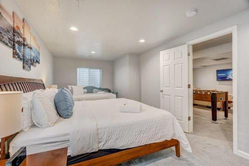 a bedroom with two beds and a bedroom with a pool at Orchid Oasis - 2 Kings Foosball BBQ Fire Pit in Colorado Springs