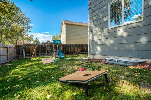 a ping pong table in a yard next to a house at Hearth Haven - Hot Tub BBQ Large Groups in Colorado Springs