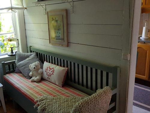 a teddy bear sitting on a bench in a room at Amazing Home In Vittsjö With 1 Bedrooms in Vittsjö
