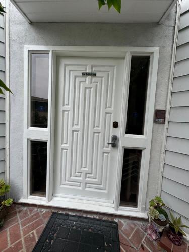 a white door with a cross on it on a house at Large Luxury Studio with View in Santa Monica in Santa Monica