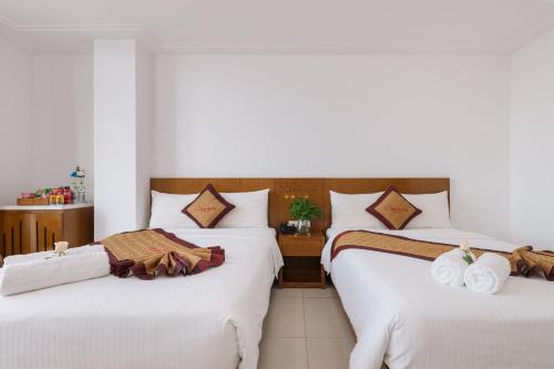 Star Hotel and Spa Danangにあるベッド