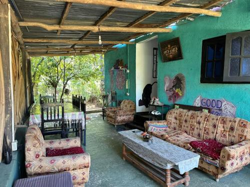 a living room with couches and a table at Cozy House Hostel in Ella