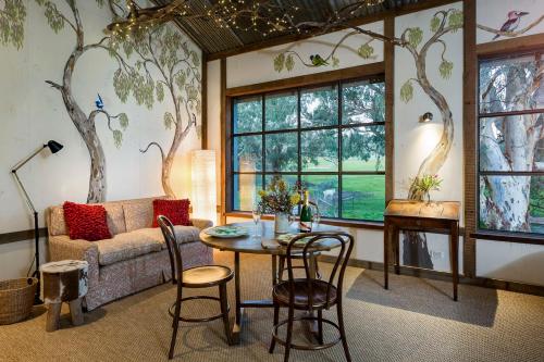 a living room with a couch and a table at AL RU Farm in Sampsons Flat