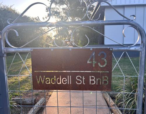 a metal gate with a sign on it at #2 Waddell Studio Apartment in Canowindra