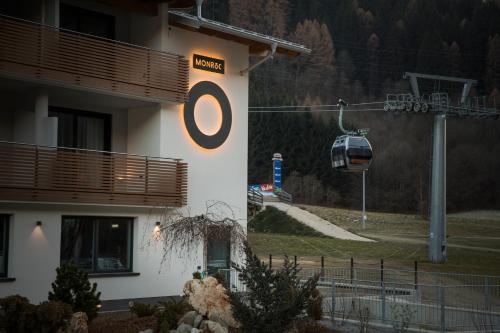 a building with a gazebo and a ski lift at Monroc Hotel in Commezzadura