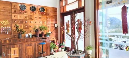 a room with many potted plants on the wall at Hoa Mộc Hotel MC - by BAY LUXURY in Làng Môn