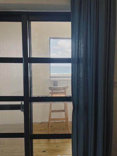 a view of a room with a window and a chair at 綠島一直曬太陽旅宿SunnyDayHostel in Green Island