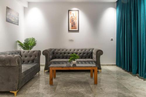 a living room with two couches and a coffee table at Host jatin Corner Cottage kasauli 7o1827o7o3 in Kasauli