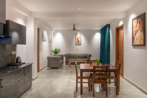 a kitchen and living room with a table and chairs at Host jatin Corner Cottage kasauli 7o1827o7o3 in Kasauli