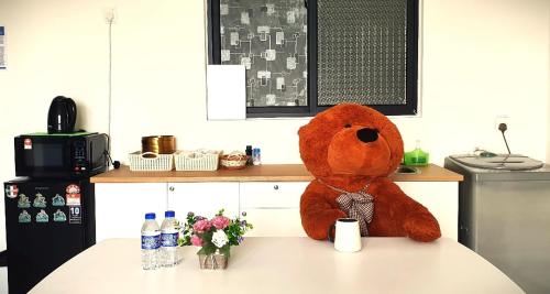 a large teddy bear sitting on top of a table at Spectacular city view Near Georgetown 9 pax in Jelutong