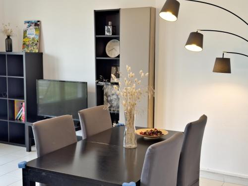 une salle à manger avec une table et des chaises noires dans l'établissement Vue Incroyable, Lumineux & Calme, à Marseille