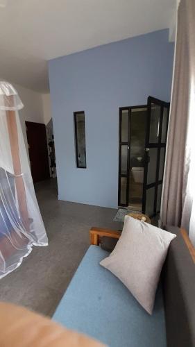 a living room with a couch and a mirror at SriMany in Mirissa