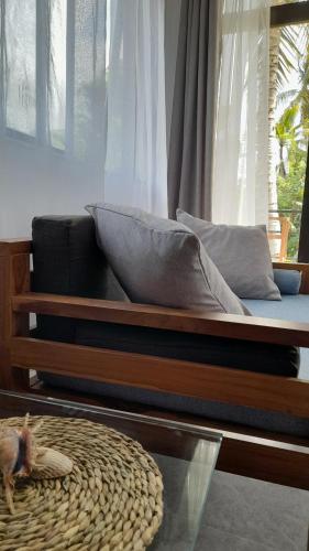 a bed with a glass table in a living room at SriMany in Mirissa