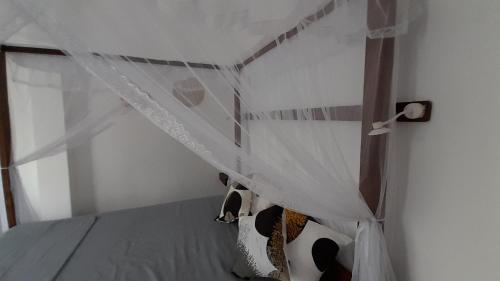 a bedroom with a bed with a canopy at SriMany in Mirissa