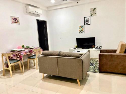 a living room with a couch and a table at Cozy Shaftsbury Netflix tv box pakin wifi king bed netflix wifi free parking 1116 in Cyberjaya