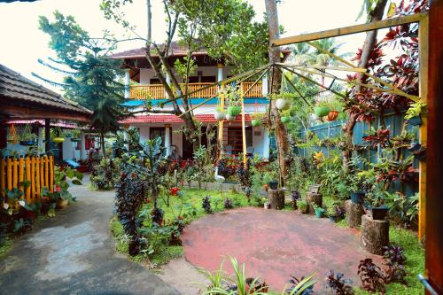 a garden in front of a house with plants at Marari John Villa in Mararikulam