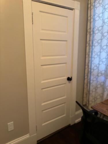 a white door in a room with a table at HomeStay in Boston - Dorchester Fields Corner Area in Boston